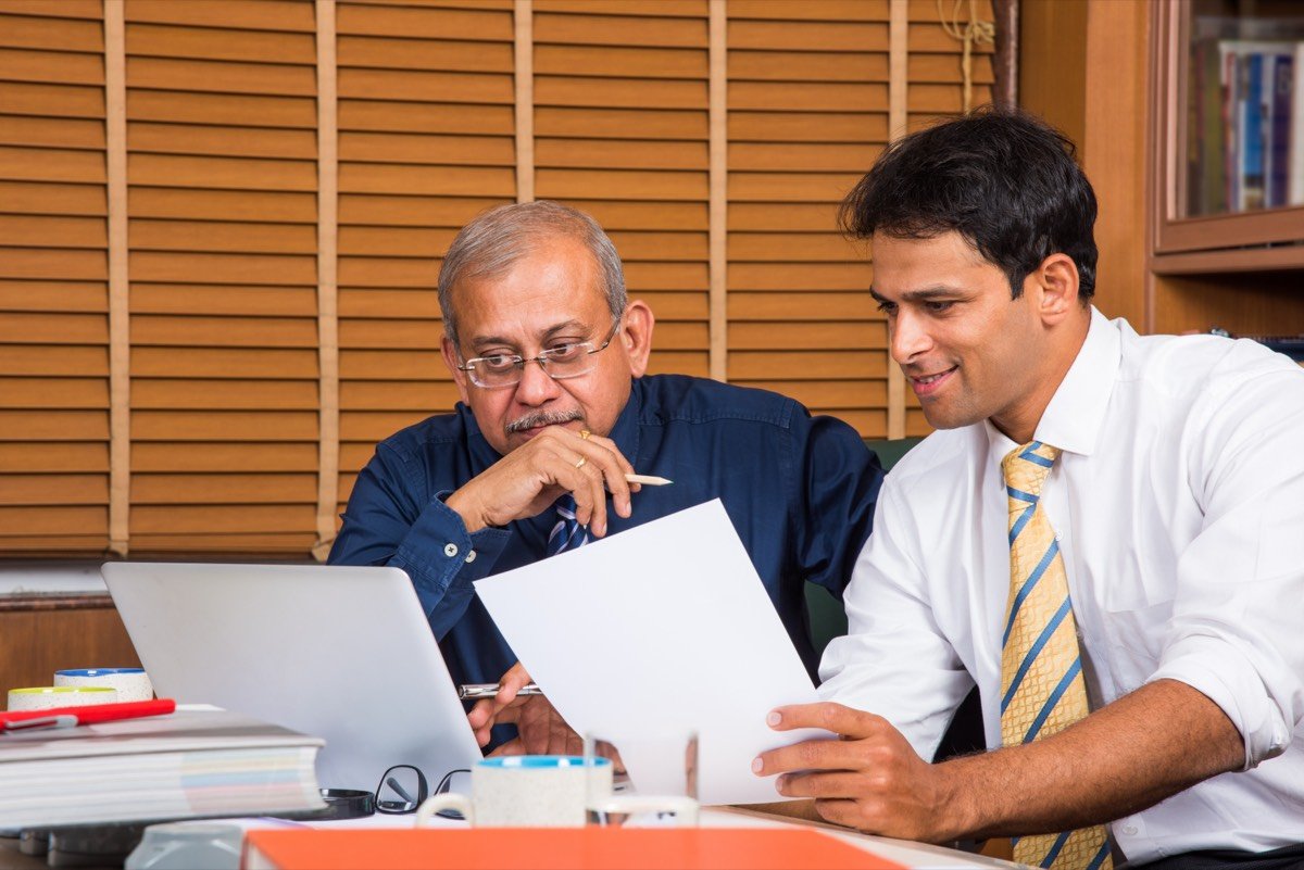 An Indian advisor explaining policy documents to a client